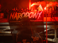 A large banner featuring a figure wearing a white supremacist symbol, a Celtic cross is seen during the Independence Day march in Warsaw, Po...