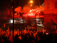 A large banner featuring a figure wearing a white supremacist symbol, a Celtic cross is seen during the Independence Day march in Warsaw, Po...