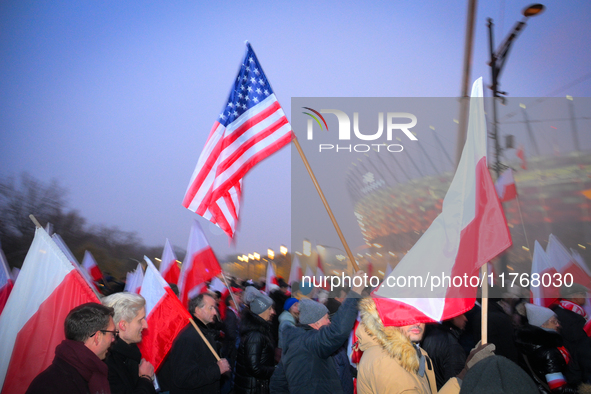 A participant holds an American flag during the Independence Day march in Warsaw, Poland on 11 November, 2024. A march organized by far-righ...