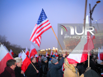 A participant holds an American flag during the Independence Day march in Warsaw, Poland on 11 November, 2024. A march organized by far-righ...