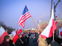 A participant holds an American flag during the Independence Day march in Warsaw, Poland on 11 November, 2024. A march organized by far-righ...