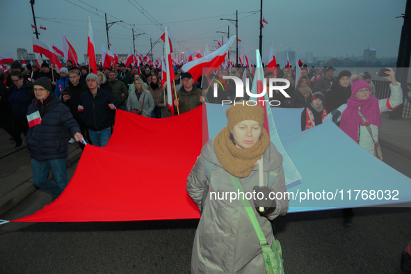 Pariticpants hold a Polish flag in Warsaw, Poland on 11 November, 2024. A march organized by far-right, nationalist organizations was allowe...