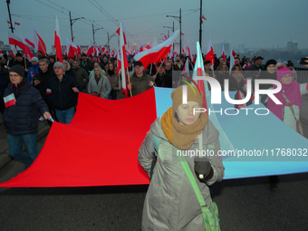 Pariticpants hold a Polish flag in Warsaw, Poland on 11 November, 2024. A march organized by far-right, nationalist organizations was allowe...