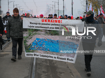 People hold a banner with text referring to Polish vicitms of the second Wolrd War Ukrainian Insurgent Army (OUN-UPA) in Warsaw, Poland on 1...