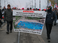 People hold a banner with text referring to Polish vicitms of the second Wolrd War Ukrainian Insurgent Army (OUN-UPA) in Warsaw, Poland on 1...