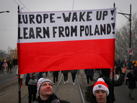 People hold a banner readubg ''Europe - Wake up! Learn from Poland!'' in Warsaw, Poland on 11 November, 2024. A march organized by far-right...