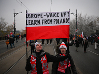 People hold a banner readubg ''Europe - Wake up! Learn from Poland!'' in Warsaw, Poland on 11 November, 2024. A march organized by far-right...