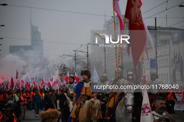 People take part in marking the 106th independence celebration in Warsaw, Poland on 11 November, 2024. A march organized by far-right, natio...