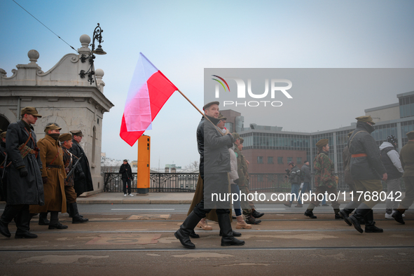 A man holds a Polish flag during the Independence Day march in Warsaw, Poland on 11 November, 2024. A march organized by far-right, national...