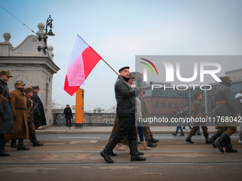 A man holds a Polish flag during the Independence Day march in Warsaw, Poland on 11 November, 2024. A march organized by far-right, national...