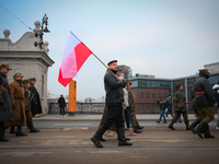 A man holds a Polish flag during the Independence Day march in Warsaw, Poland on 11 November, 2024. A march organized by far-right, national...