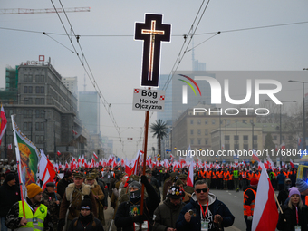 A man olds a cross during the Independence Day march in Warsaw, Poland on 11 November, 2024. A march organized by far-right, nationalist org...