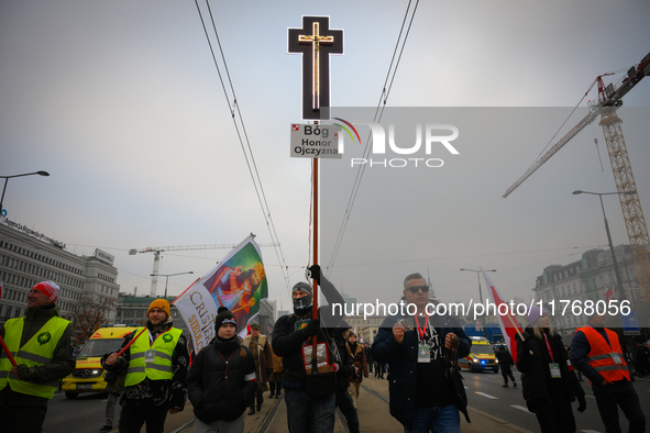 A man olds a cross during the Independence Day march in Warsaw, Poland on 11 November, 2024. A march organized by far-right, nationalist org...