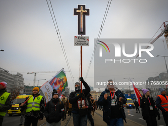 A man olds a cross during the Independence Day march in Warsaw, Poland on 11 November, 2024. A march organized by far-right, nationalist org...