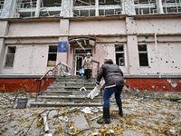 Women help with cleaning the sports complex of the Zaporizhzhia Polytechnic National University damaged by an overnight Russian air strike i...