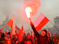 A man lights a flare during inedpendence day celebrations in Warsaw, Poland on 11 November, 2024. A march organized by far-right, nationalis...