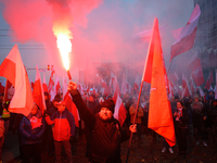 A man lights a flare during inedpendence day celebrations in Warsaw, Poland on 11 November, 2024. A march organized by far-right, nationalis...