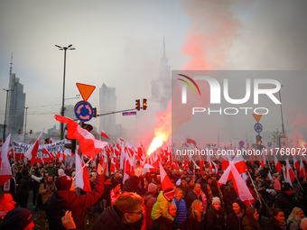 People take part in marking the 106th independence celebration in Warsaw, Poland on 11 November, 2024. A march organized by far-right, natio...