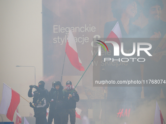 People take part in marking the 106th independence celebration in Warsaw, Poland on 11 November, 2024. A march organized by far-right, natio...