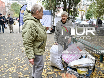 Elderly women talk by salvaged belongings outside a hostel where internally displaced persons live, damaged by an overnight Russian air stri...