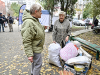 Elderly women talk by salvaged belongings outside a hostel where internally displaced persons live, damaged by an overnight Russian air stri...