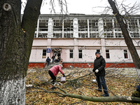 People remove debris from the premises of the sports complex of the Zaporizhzhia Polytechnic National University damaged by an overnight Rus...