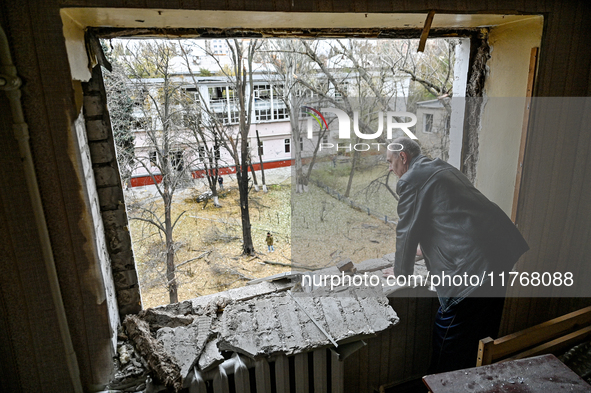 In Zaporizhzhia, Ukraine, on November 11, 2024, a man looks out of a knocked-out window in a room of a hostel where internally displaced per...