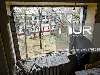 In Zaporizhzhia, Ukraine, on November 11, 2024, a man looks out of a knocked-out window in a room of a hostel where internally displaced per...