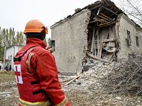 A volunteer looks at an apartment block where a child is injured after an overnight Russian air strike in Zaporizhzhia, Ukraine, on November...