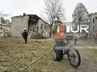 Rescuers and volunteers are outside an apartment block where a child is injured after an overnight Russian air strike in Zaporizhzhia, Ukrai...