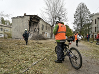 Rescuers and volunteers are outside an apartment block where a child is injured after an overnight Russian air strike in Zaporizhzhia, Ukrai...