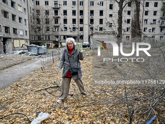 A woman captures the consequence of an overnight Russian air strike with a smartphone in the yard of a hostel where internally displaced per...