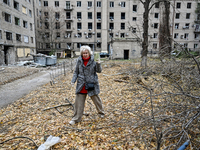 A woman captures the consequence of an overnight Russian air strike with a smartphone in the yard of a hostel where internally displaced per...