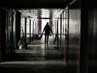 A woman with a broom walks along a corridor in a hostel where internally displaced persons live that is damaged by an overnight Russian air...