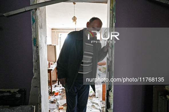 A man leaves a room in a hostel where internally displaced persons live that is damaged by an overnight Russian air strike in Zaporizhzhia,...