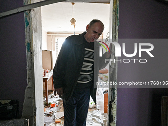 A man leaves a room in a hostel where internally displaced persons live that is damaged by an overnight Russian air strike in Zaporizhzhia,...