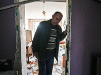 A man leaves a room in a hostel where internally displaced persons live that is damaged by an overnight Russian air strike in Zaporizhzhia,...