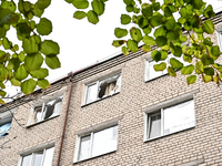 Broken windows are in a hostel where internally displaced persons live, which is damaged by an overnight Russian air strike in Zaporizhzhia,...