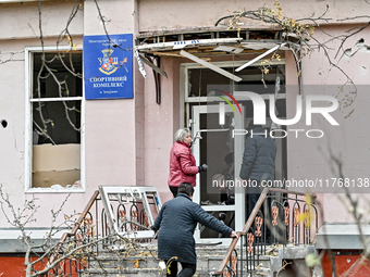 People clean the premises of the sports complex of the Zaporizhzhia Polytechnic National University damaged by an overnight Russian air stri...