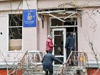 People clean the premises of the sports complex of the Zaporizhzhia Polytechnic National University damaged by an overnight Russian air stri...