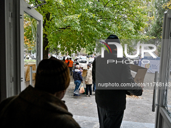 Residents of a hostel for internally displaced persons, damaged by an overnight Russian air strike, recover after the attack in Zaporizhzhia...