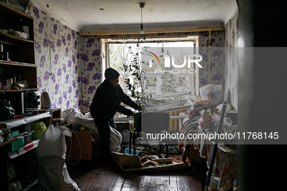 In Zaporizhzhia, Ukraine, on November 11, 2024, a woman tidies a room in a hostel where internally displaced persons live that is damaged by...