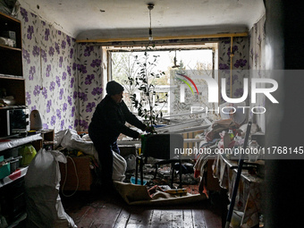 In Zaporizhzhia, Ukraine, on November 11, 2024, a woman tidies a room in a hostel where internally displaced persons live that is damaged by...