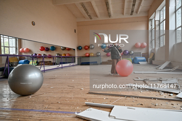 A woman looks with sadness at a gym in the sports complex of the Zaporizhzhia Polytechnic National University, which is damaged by an overni...