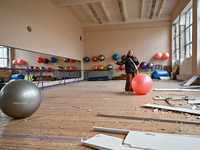 A woman looks with sadness at a gym in the sports complex of the Zaporizhzhia Polytechnic National University, which is damaged by an overni...