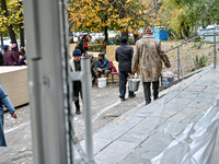 Residents stand outside a hostel where internally displaced persons live, which is damaged by an overnight Russian air strike in Zaporizhzhi...