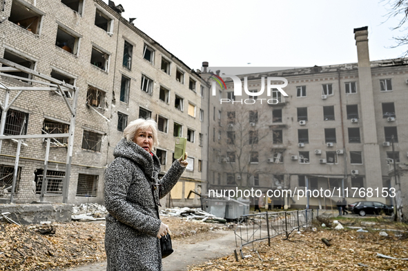 A woman captures the consequence of an overnight Russian air strike with a smartphone in the yard of a hostel where internally displaced per...