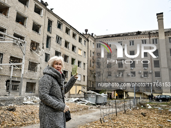 A woman captures the consequence of an overnight Russian air strike with a smartphone in the yard of a hostel where internally displaced per...