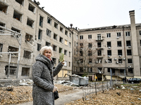 A woman captures the consequence of an overnight Russian air strike with a smartphone in the yard of a hostel where internally displaced per...