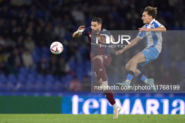 Alex Petxarroman of RC Deportivo de La Coruna competes for the ball with Antonio Puertas of SD Eibar during the LaLiga Hypermotion match bet...